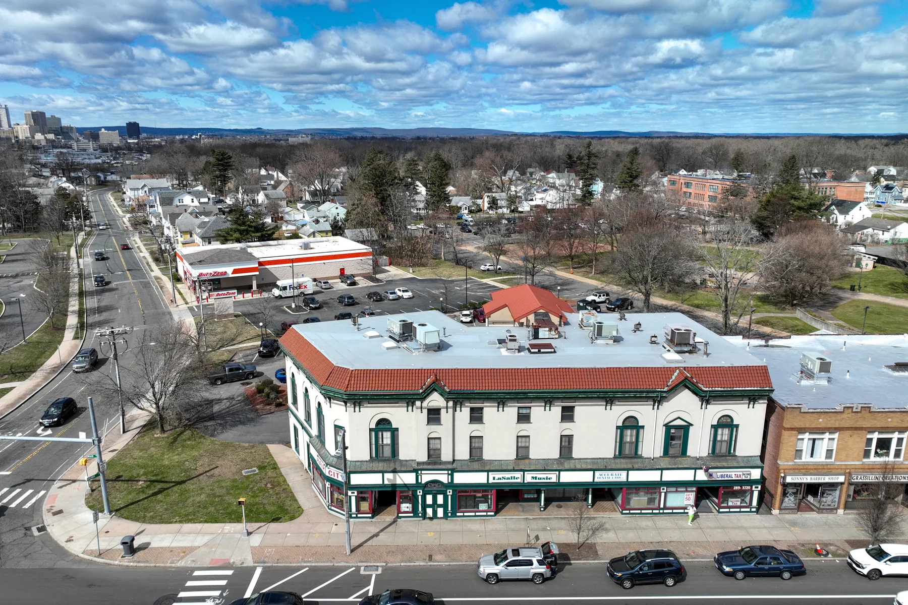 The rounded corner entrance establishes a clear Main Street presence.