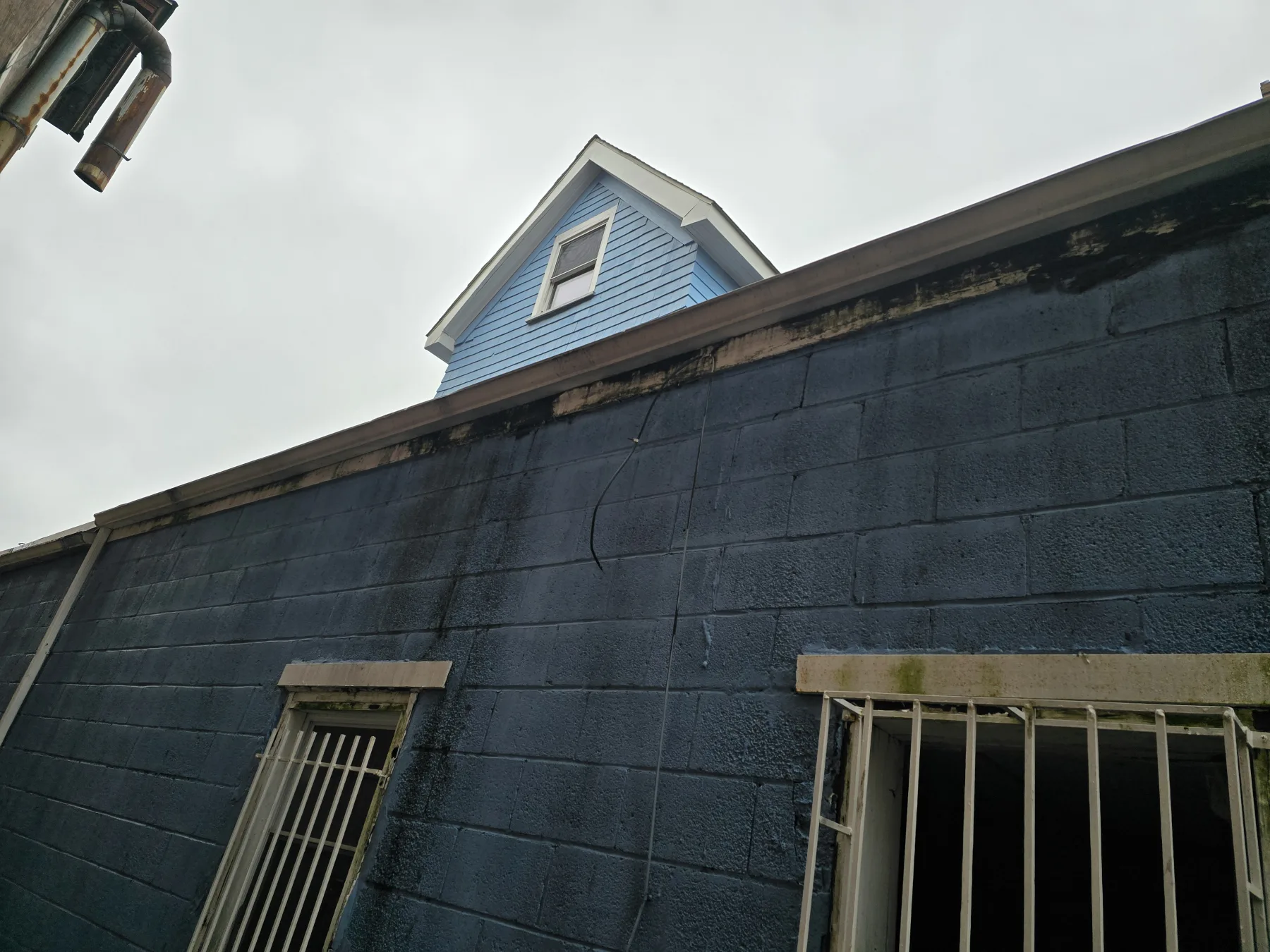 A construction-period view records additional work on the rear wall, roof edge, and masonry.