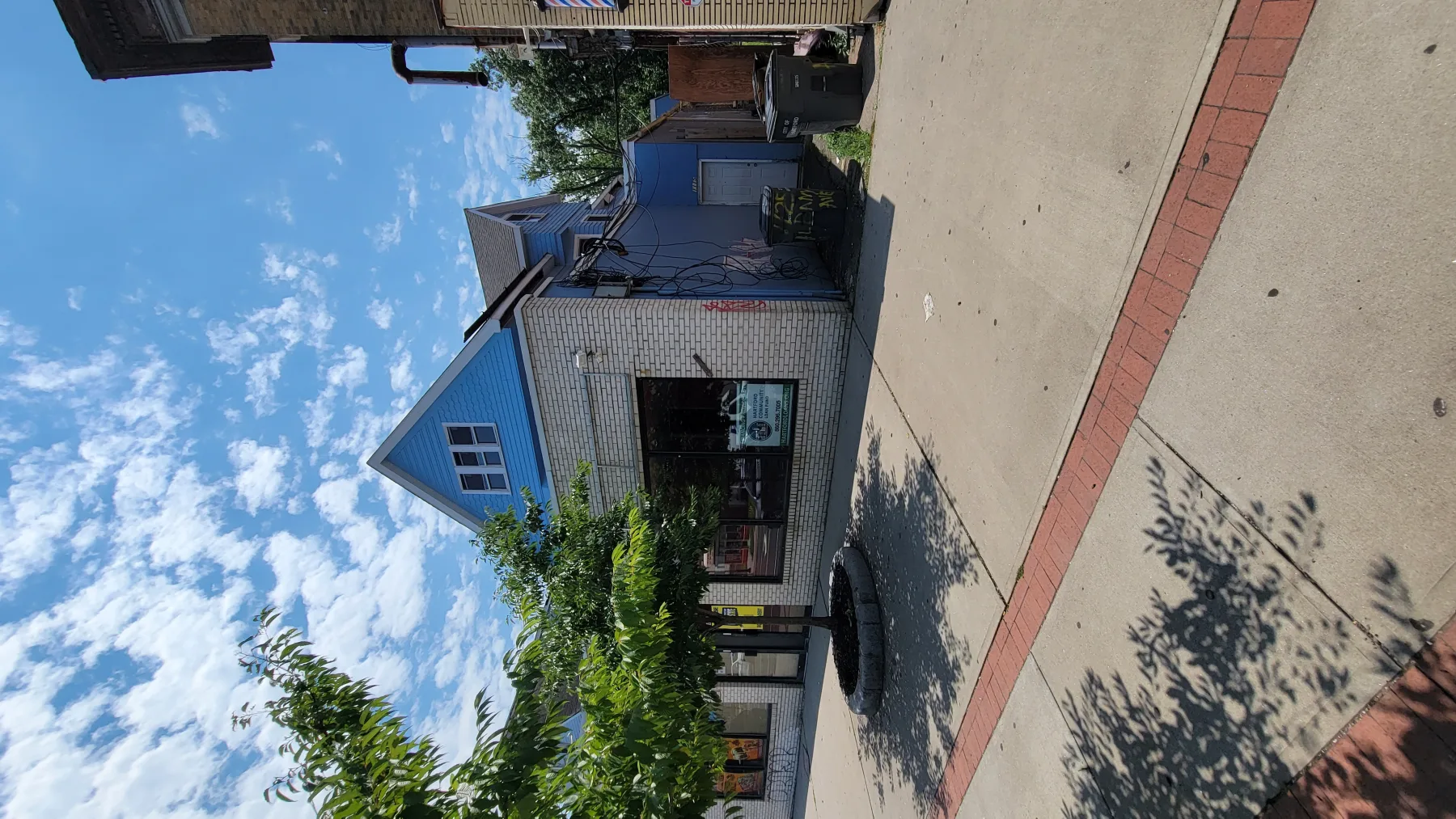A side-angle view records the building and street frontage before the new commercial façade was installed.