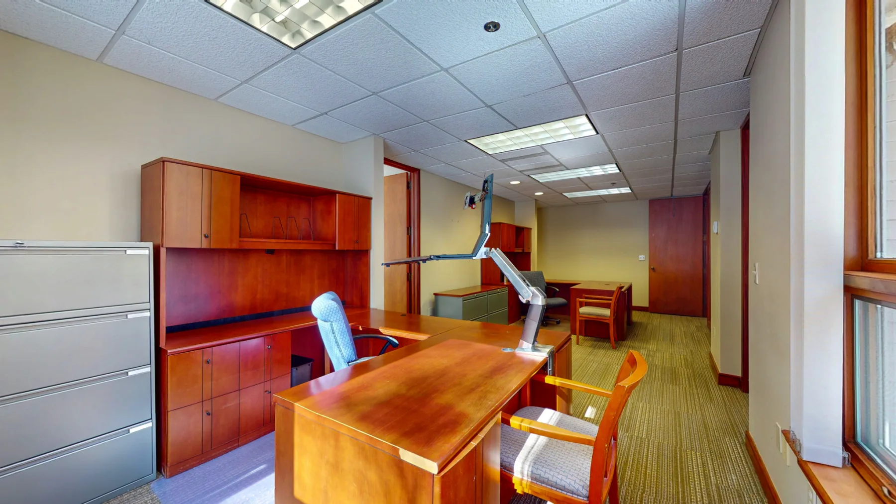 A long workstation office demonstrates the built-in furniture and window line available to a small team.