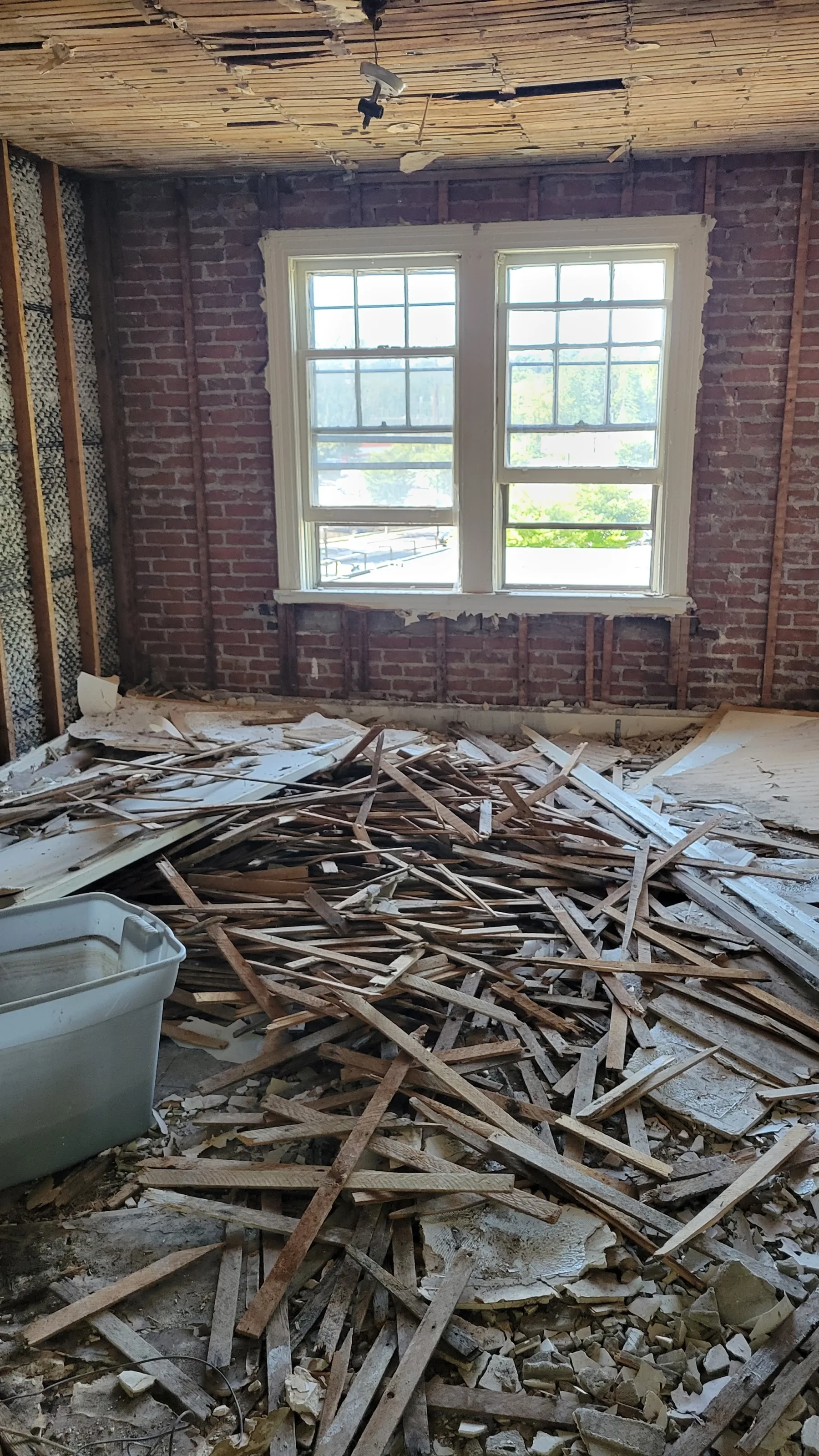 Removed plaster and lath document the difficult demolition work required to reach the original structure.