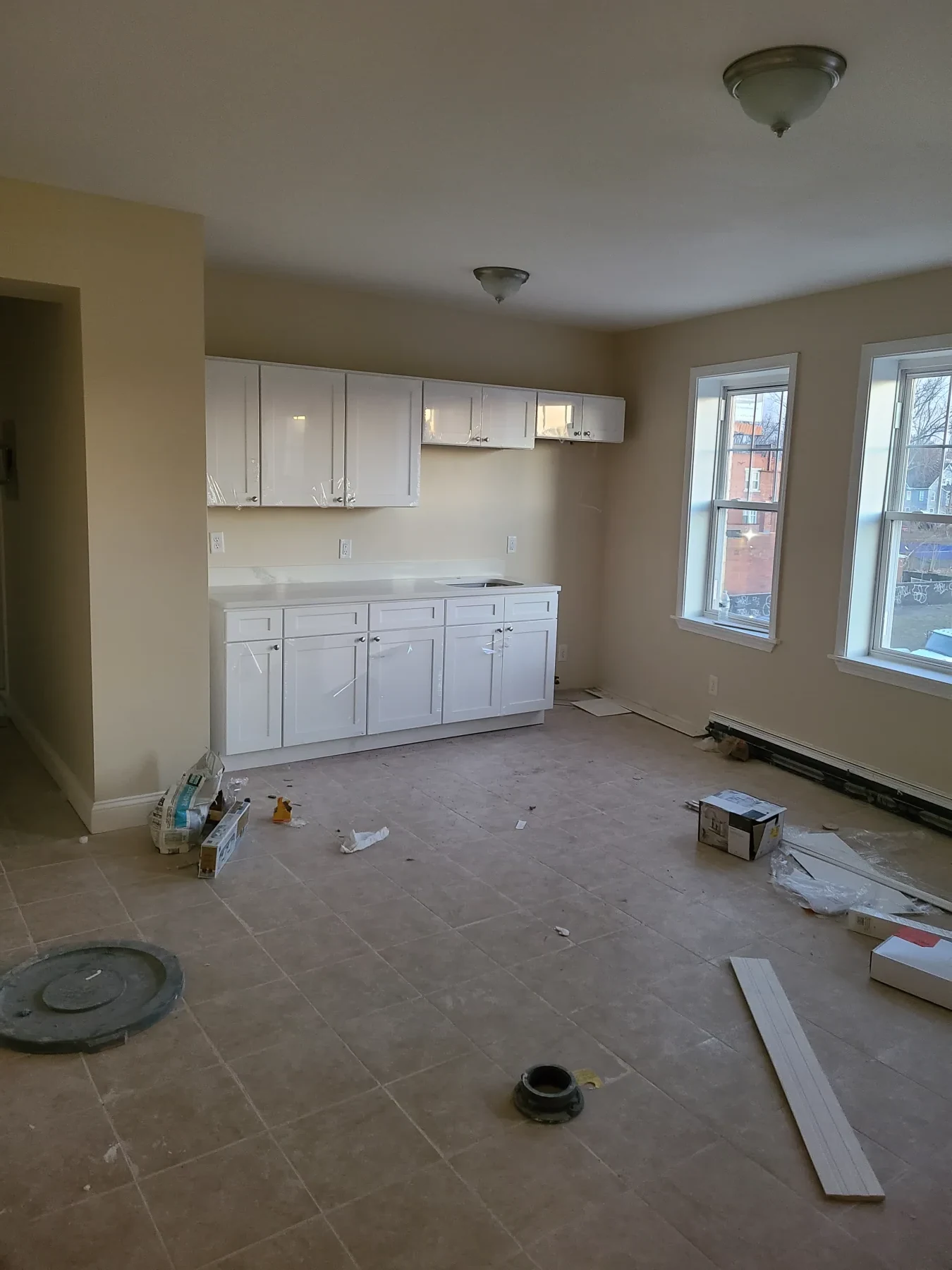 New cabinets and counters are installed while construction materials are still visible.