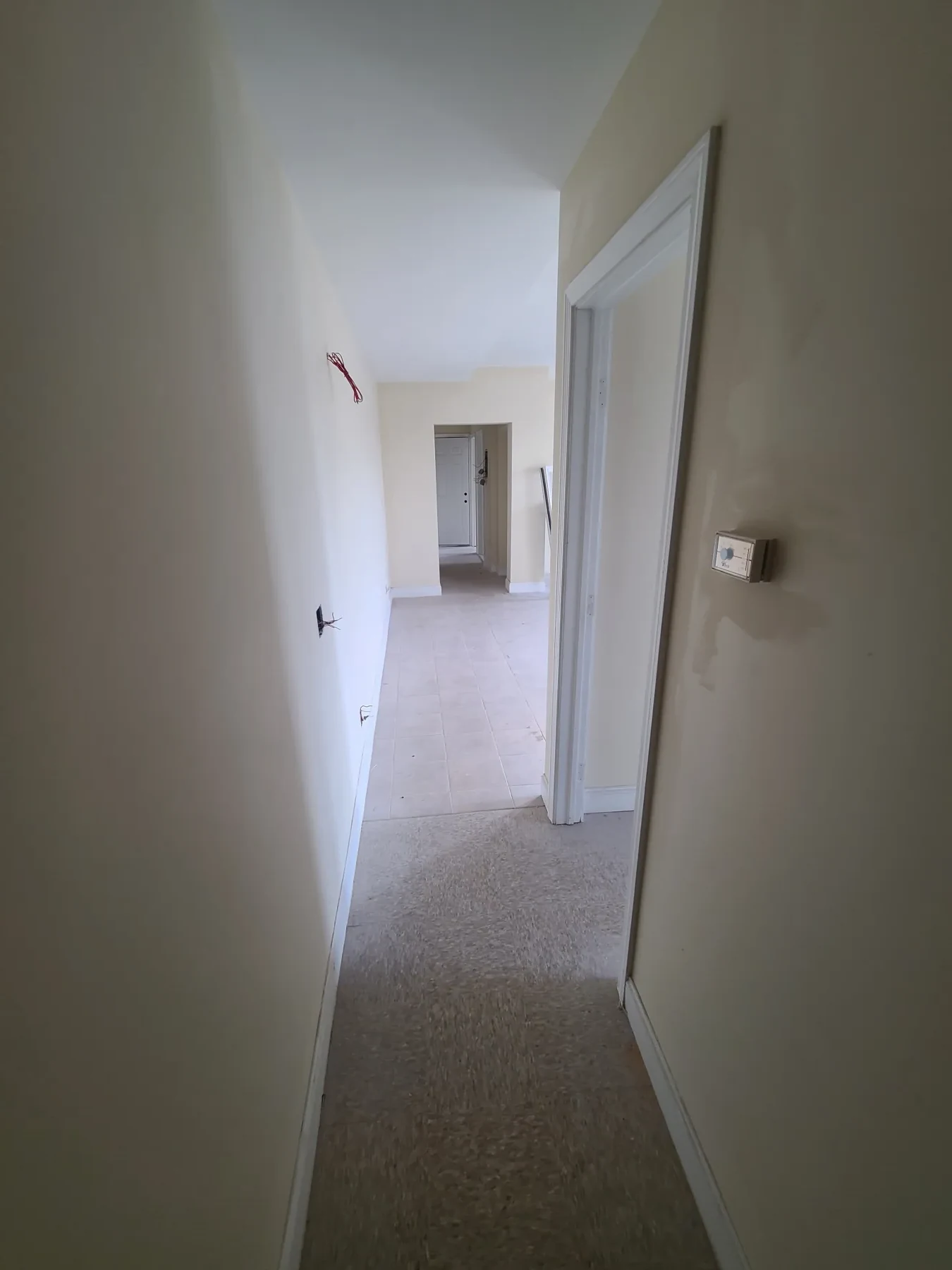 Freshly repaired walls and new trim show the apartment taking shape before final electrical work.