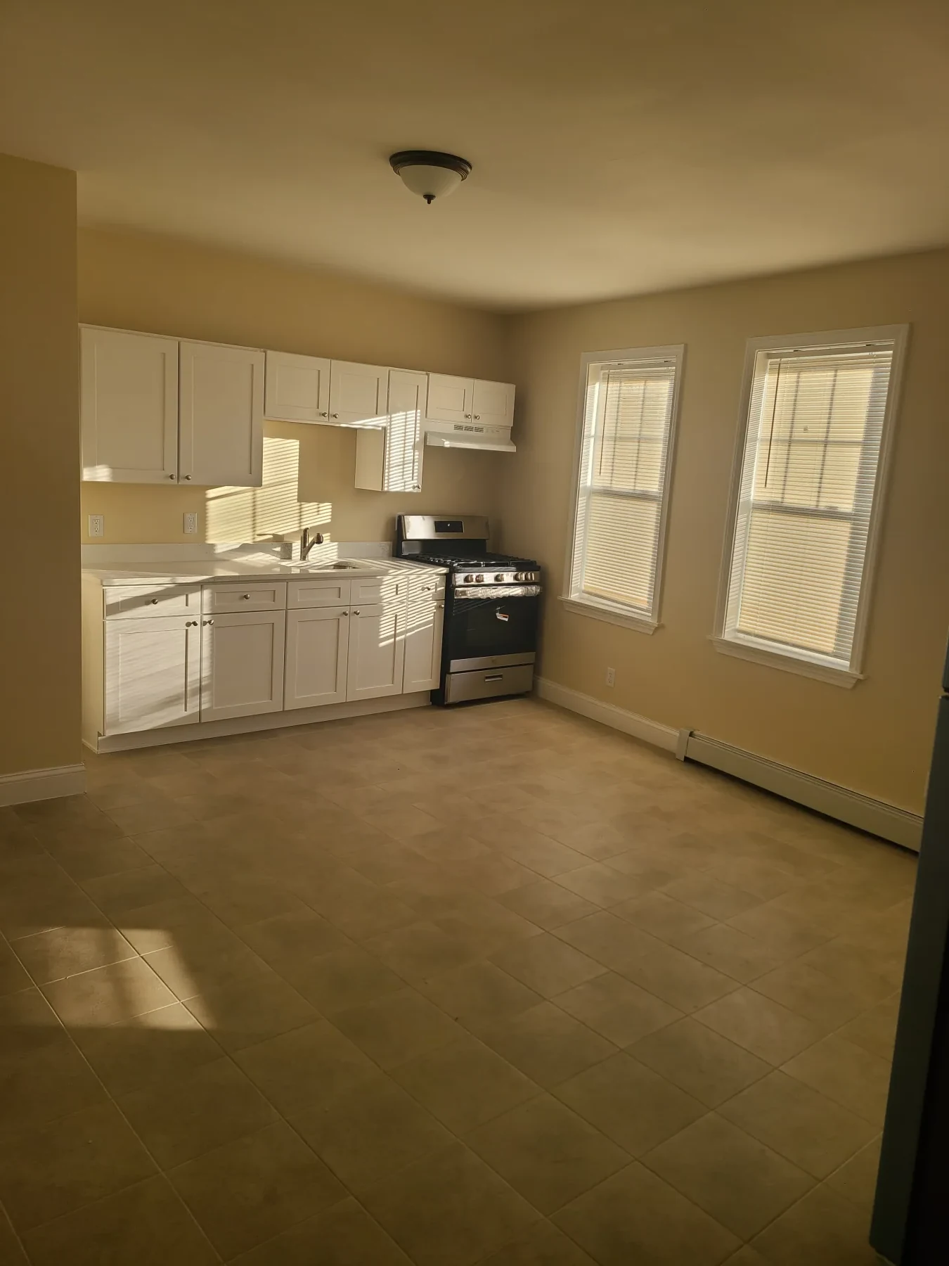 The completed kitchen adds appliances and a clean, durable finish throughout.