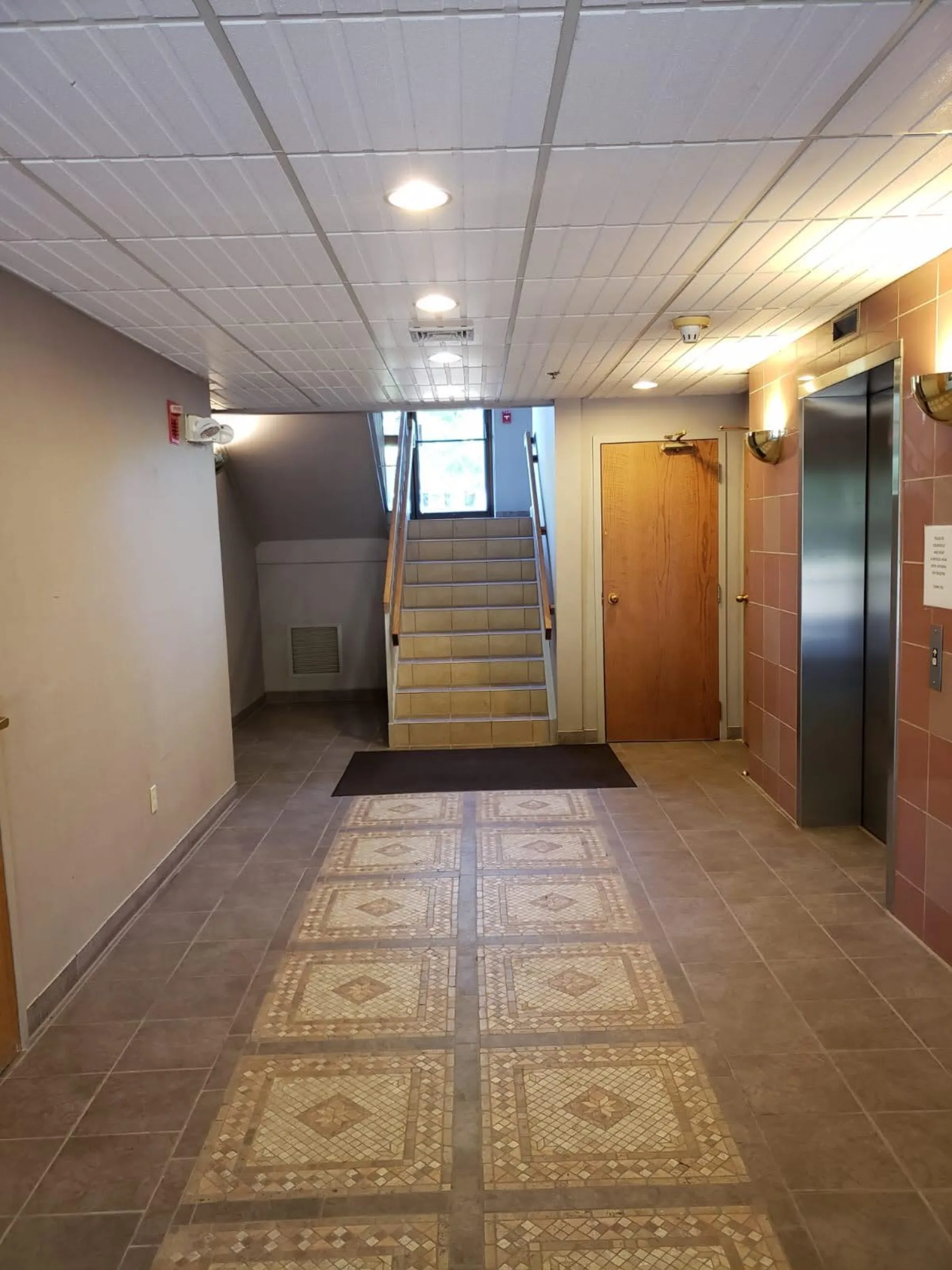 The renewed lobby and elevator approach show the work carried into shared circulation spaces.