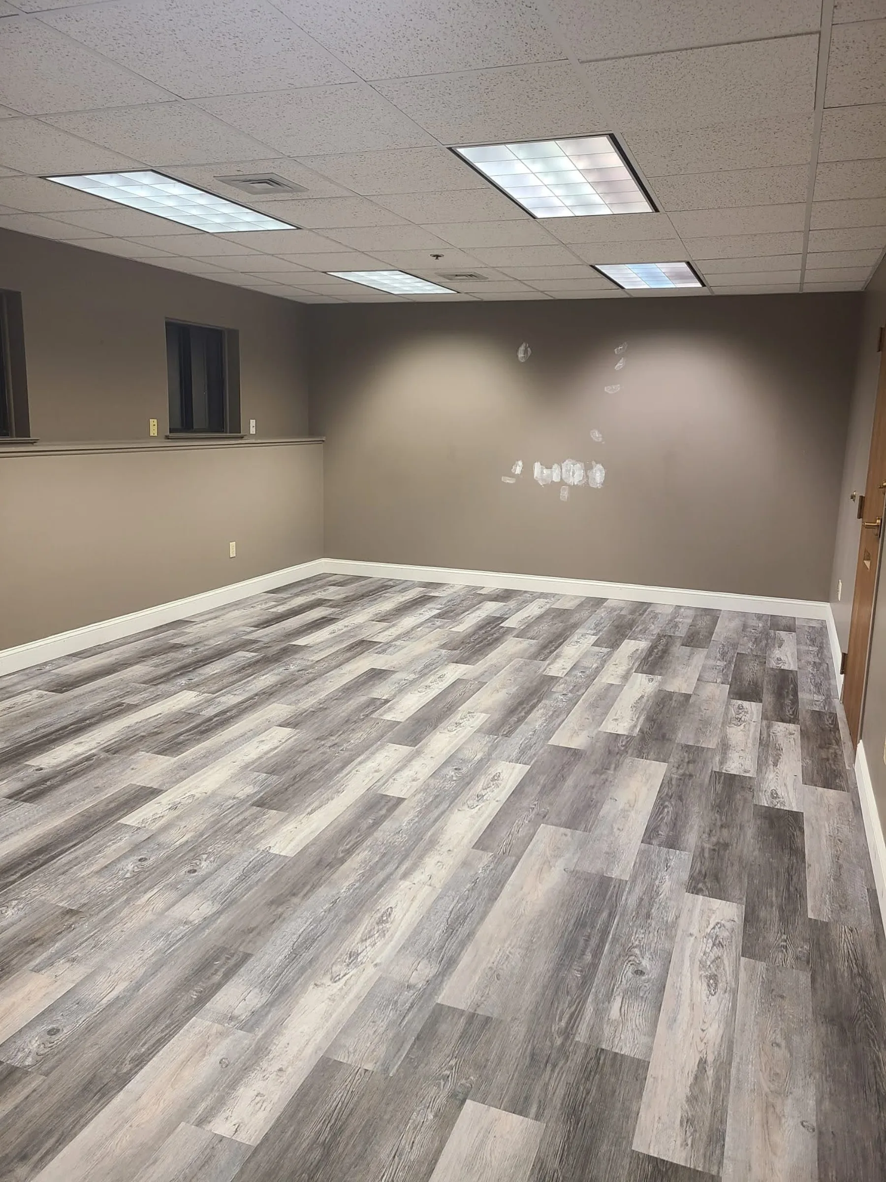 A completed office suite presents updated walls, flooring, lighting, and a flexible professional layout.