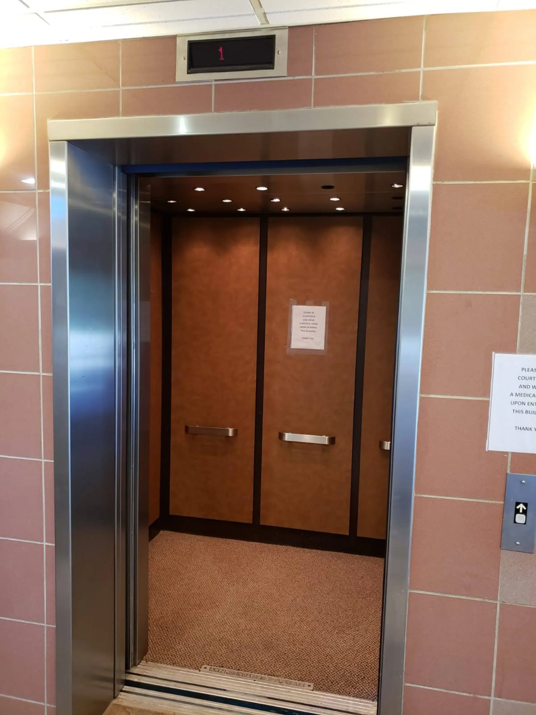 The updated elevator and tiled landing provide a clean arrival between floors.