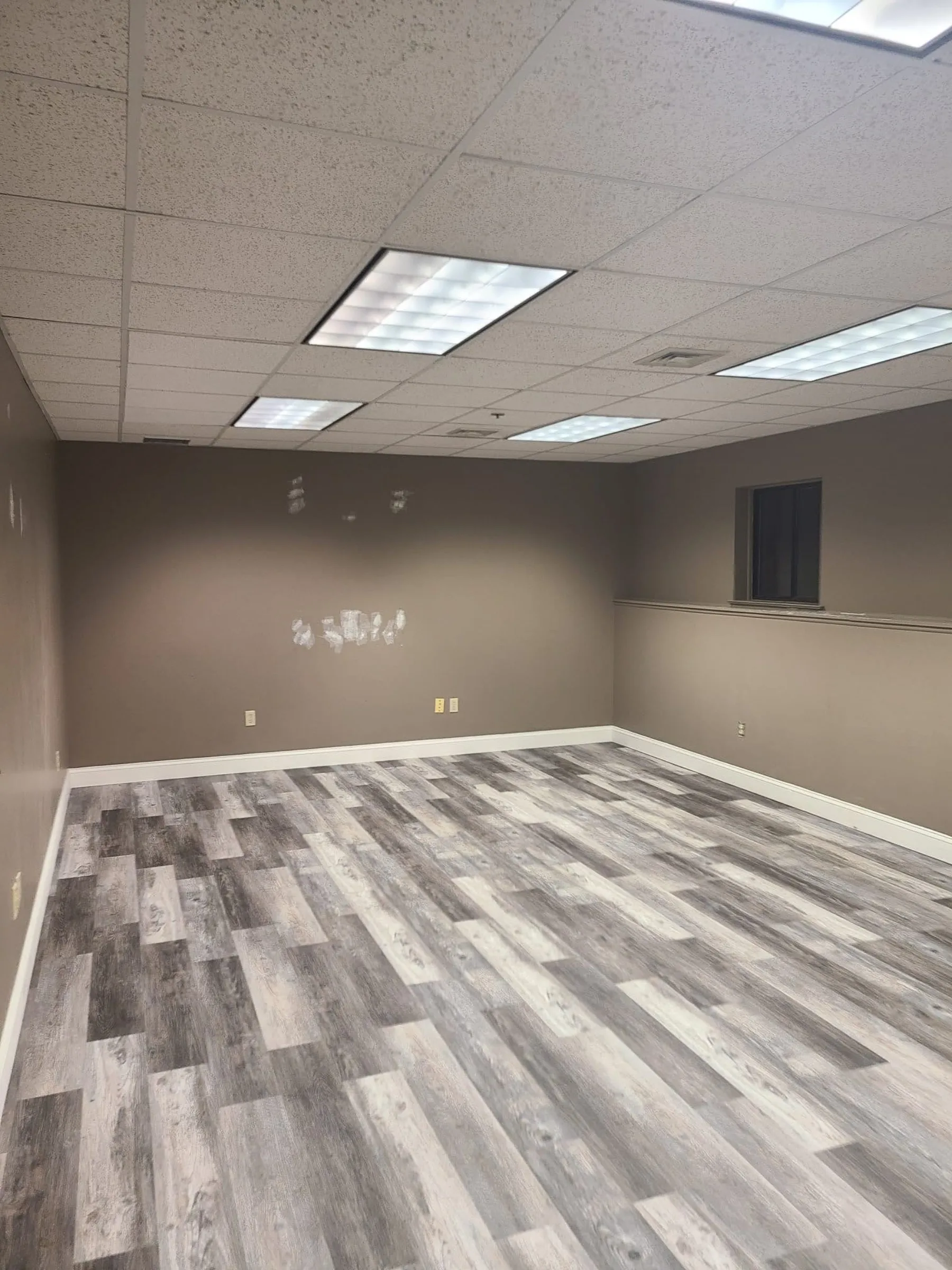 A second renovated suite shows the new resilient flooring and brighter neutral finish palette.