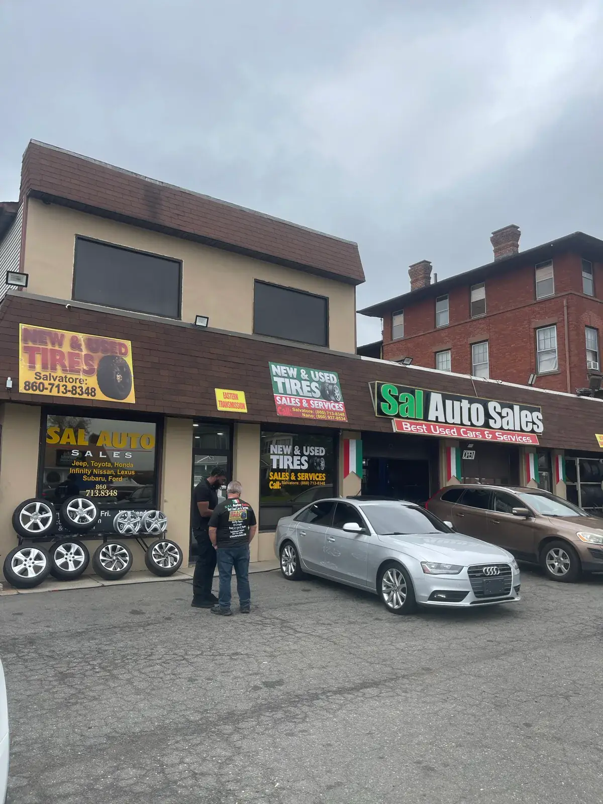 Sal’s storefront on Wethersfield Avenue, with the green Sal Auto Sales sign and wheels displayed outside